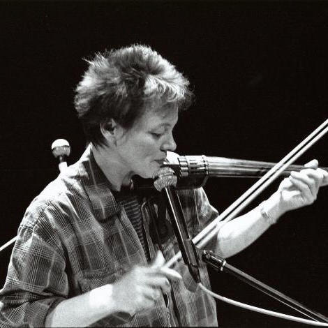 Laurie Anderson holding an electric violin.