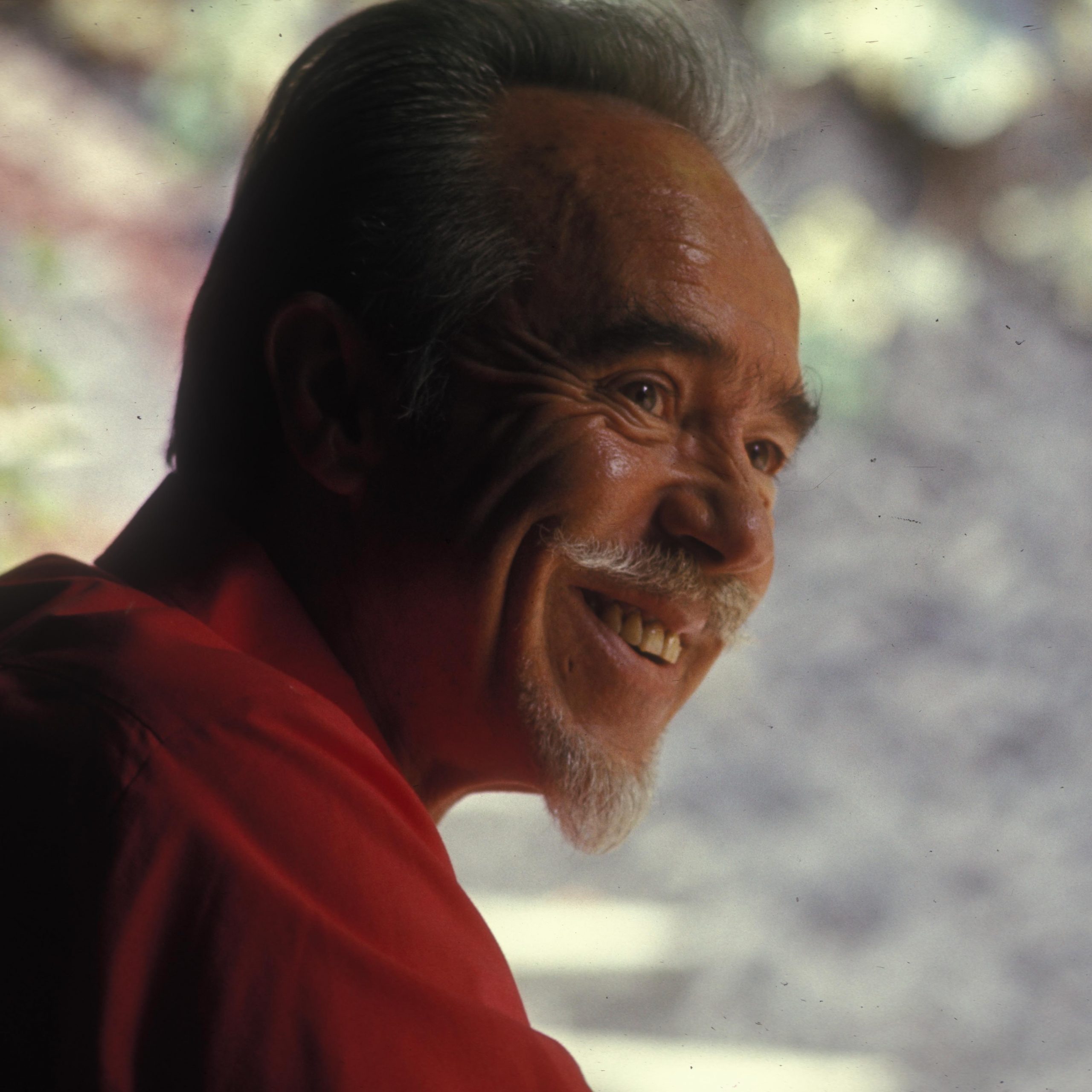 Conlon Nancarrow smiling and wearing a red shirt