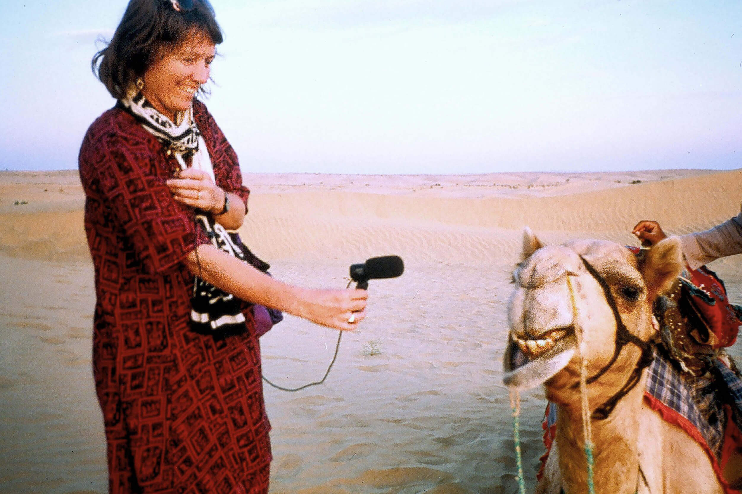 Hildegard Westerkamp recording a camel with a microphone