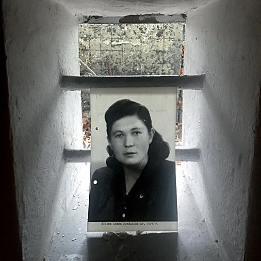 black and white photograph of a woman in a prison cell window