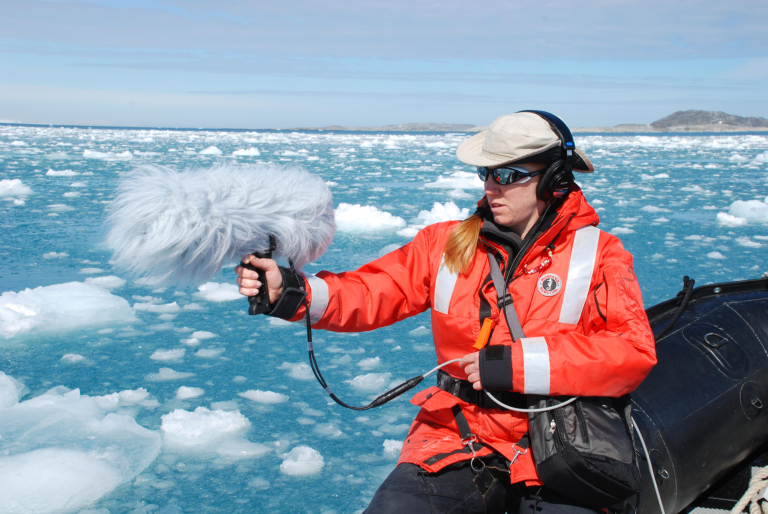 Cheryl Leonard field recording on a boat in icy water