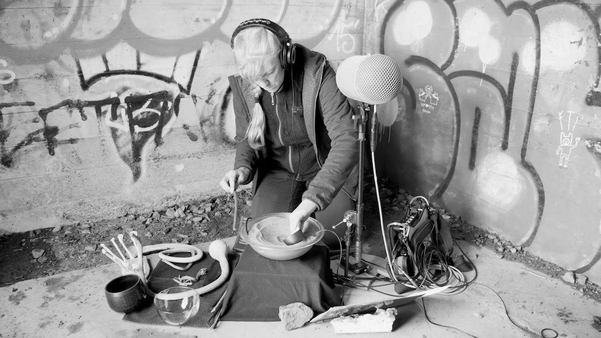 Cheryl Leonard performing with organic objects outdoors
