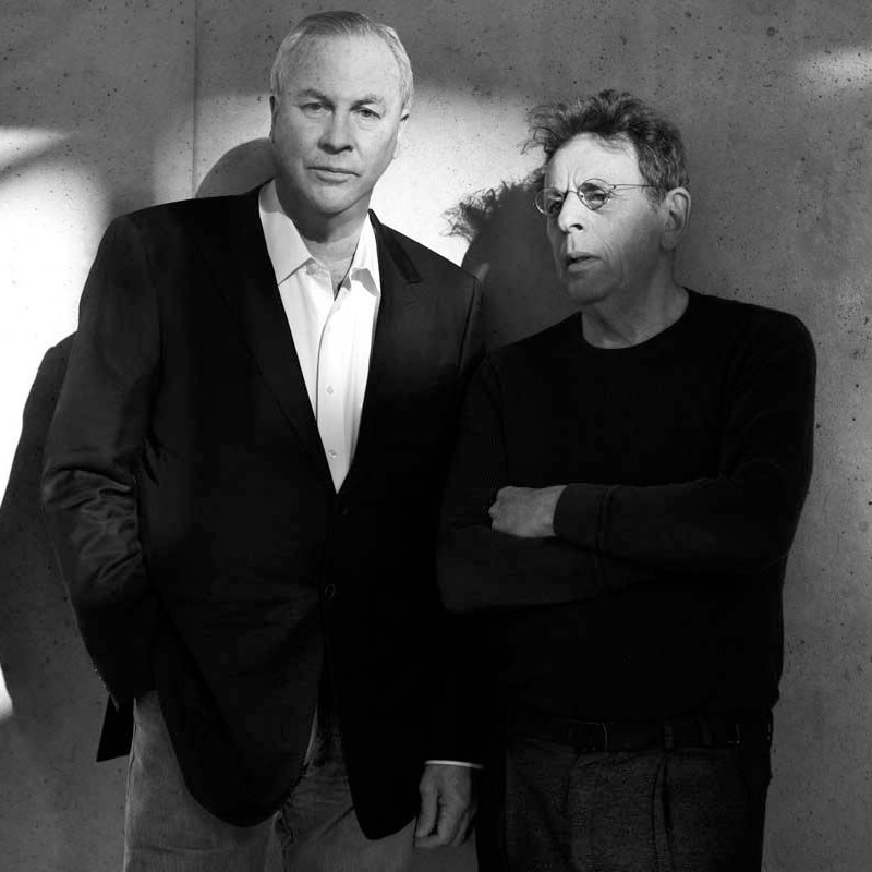Robert Wilson and Philip Glass standing in a black and white photograph.