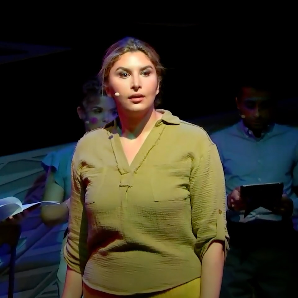 An opera singer in a green shirt.