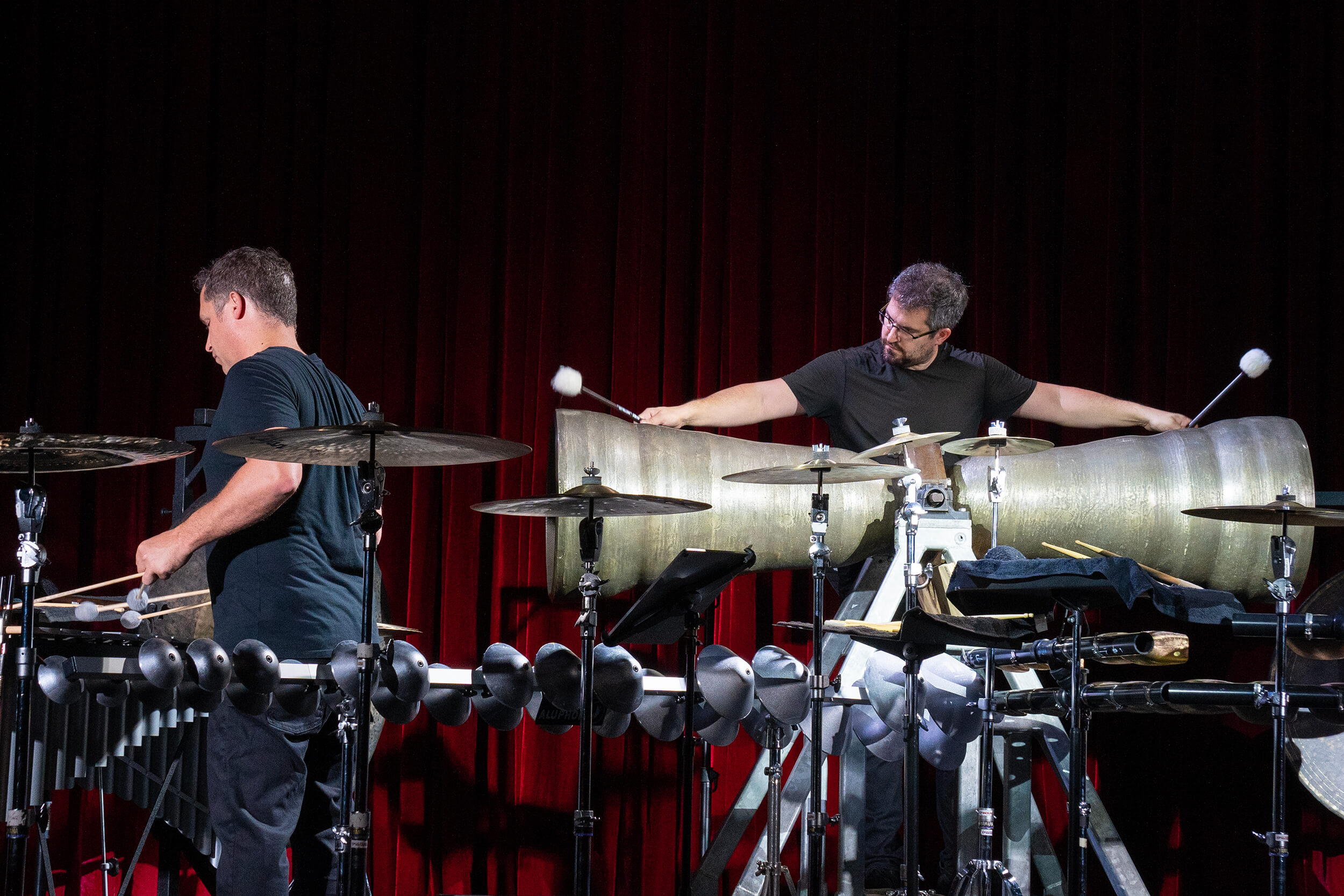 Christopher Whyte and Garrett Arney playing percussion instruments.
