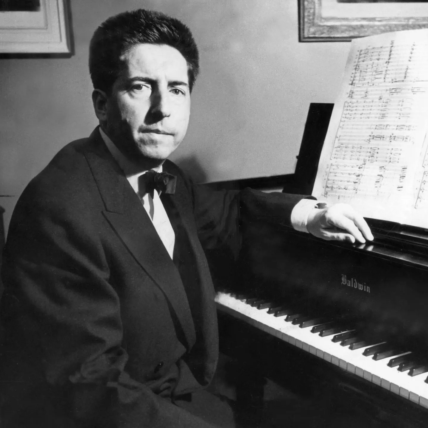 Henri Dutilleux sitting at the piano.