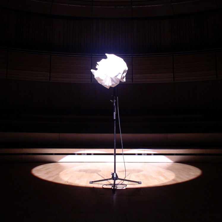 Microphone on a stand covered in a ball of paper.