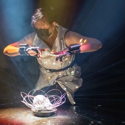 Bora Yoon performing with electronic sensors above a disco ball.