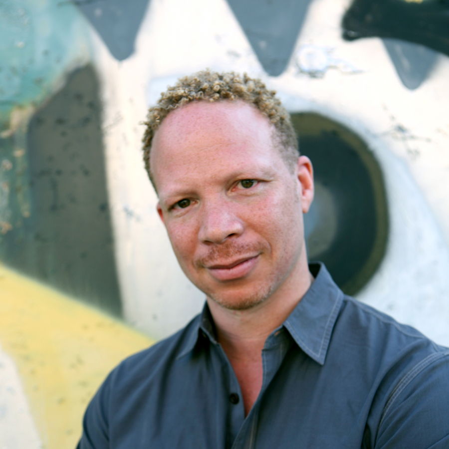 Craig Taborn standing in front of a mural