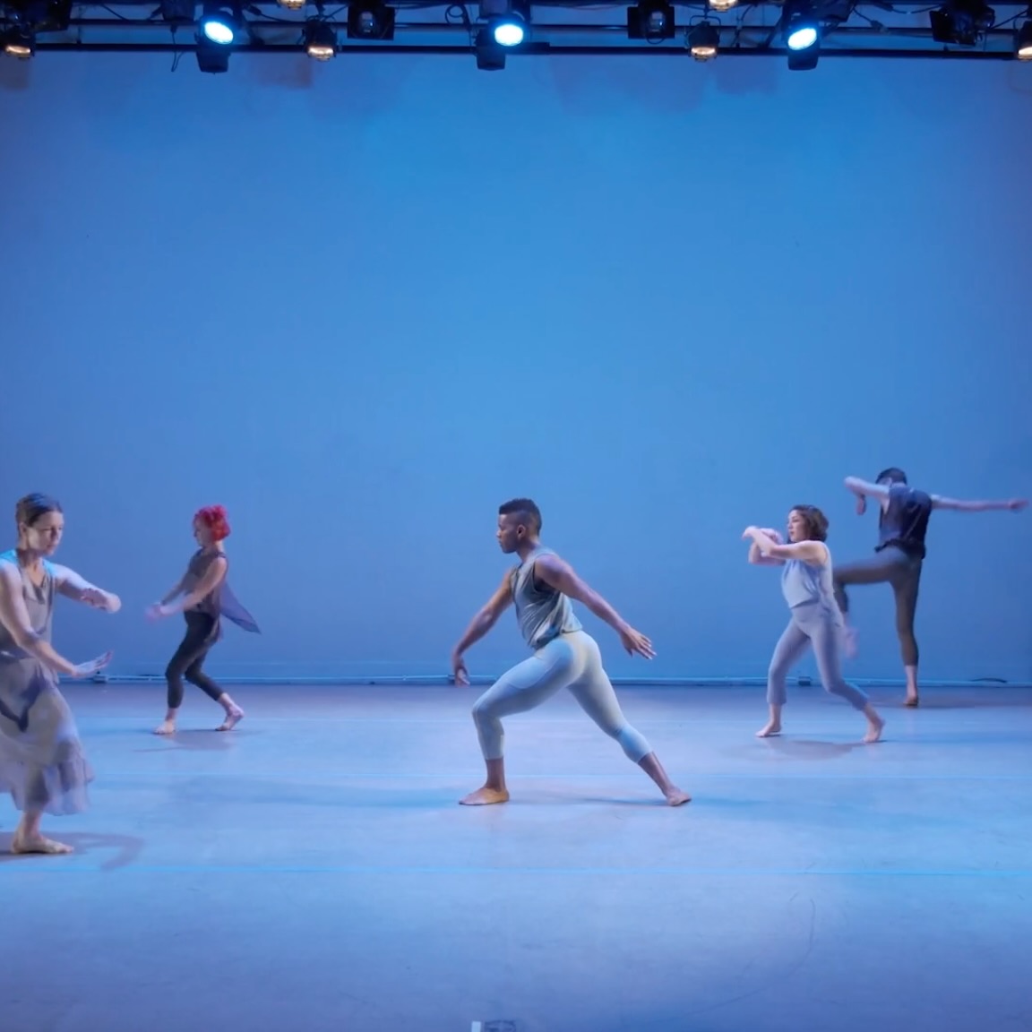 Dancers in blue light.