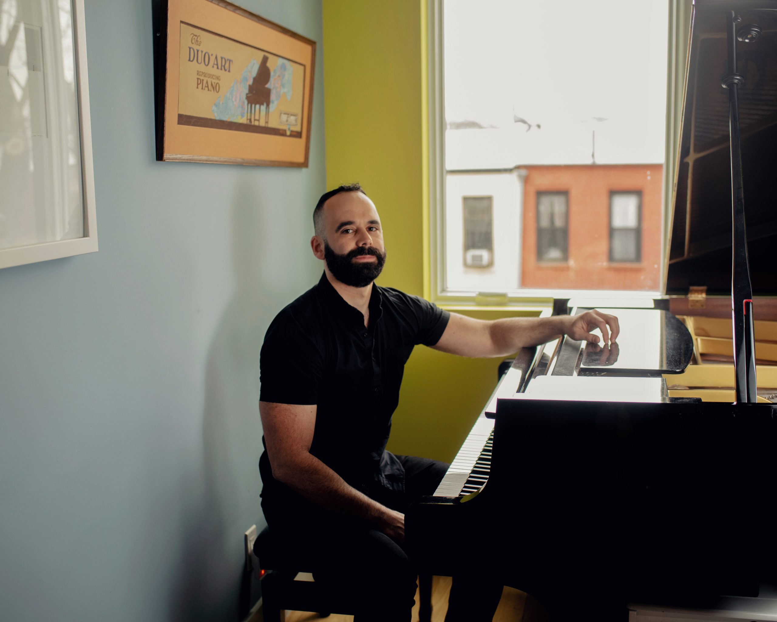 Adam Tendler sitting at the piano.