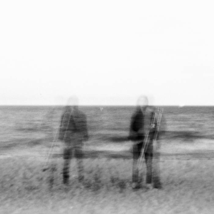 Noah Jenkins Altered black and white image of a person standing on the shore holding a trombone.
