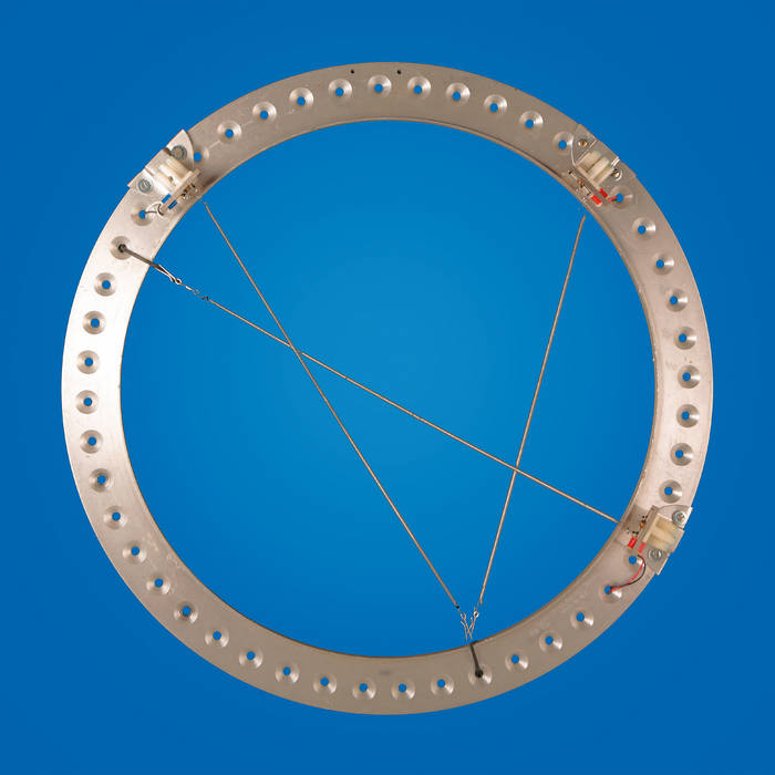 A metal ring with holes in it against a blue background