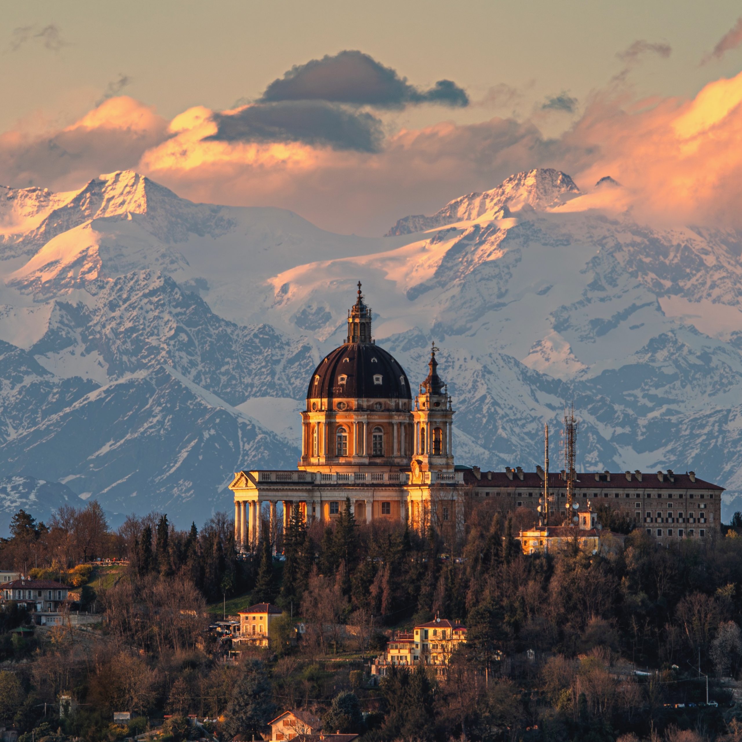 The Basilica of Superga and the Monte Rosa massif in the background at sunset.