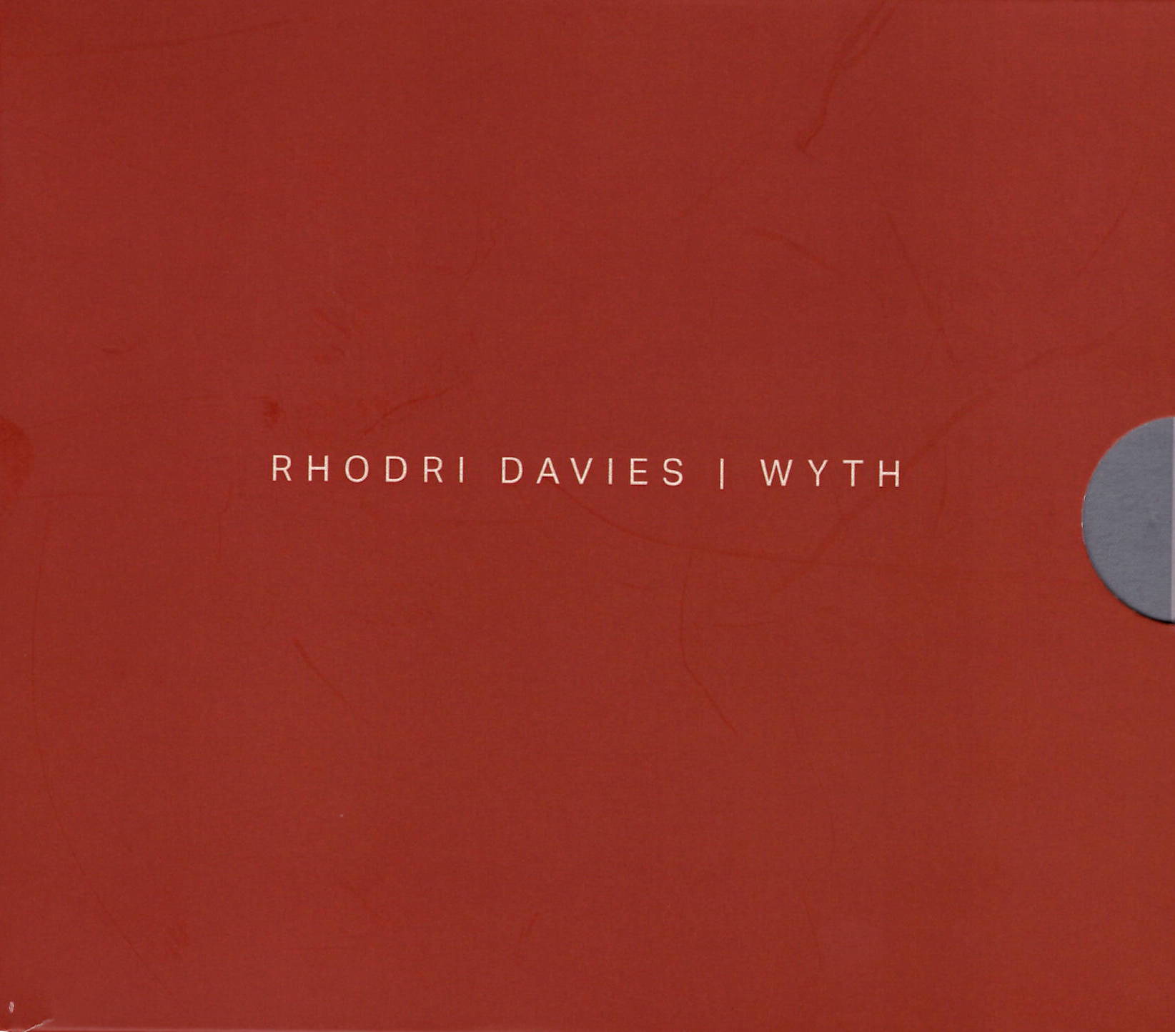 A red background with yellow colored words centered, a grey half-circle centered on the right.