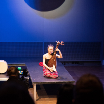Jen Shyu holding a plucked string instrument.
