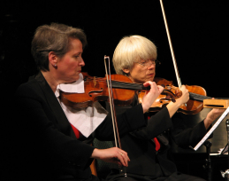 violinists playing a piece by Cowell