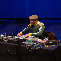 King Britt performing with electric keyboards.