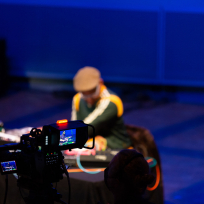 King Britt out of focus behind a camera.