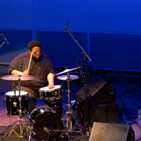 Tyshawn Sorey playing drumset.