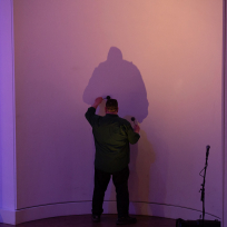 William Winant playing a wall with mallets.