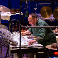 William Winant playing a multi-percussion setup.
