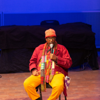 William Parker speaking into a microphone.
