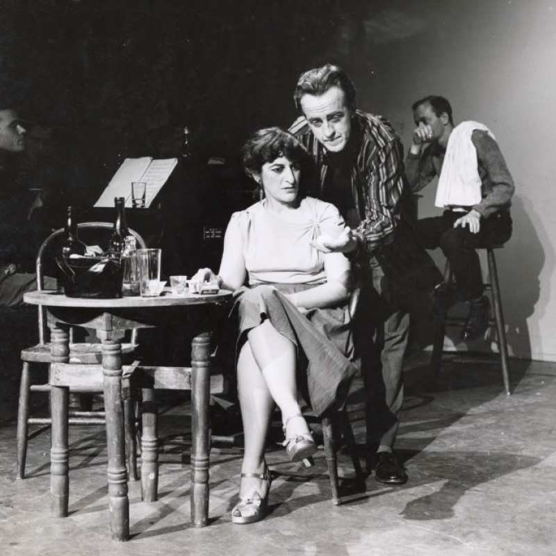 Dorothy Renzi accompanied by an unidentified man in a stage setting